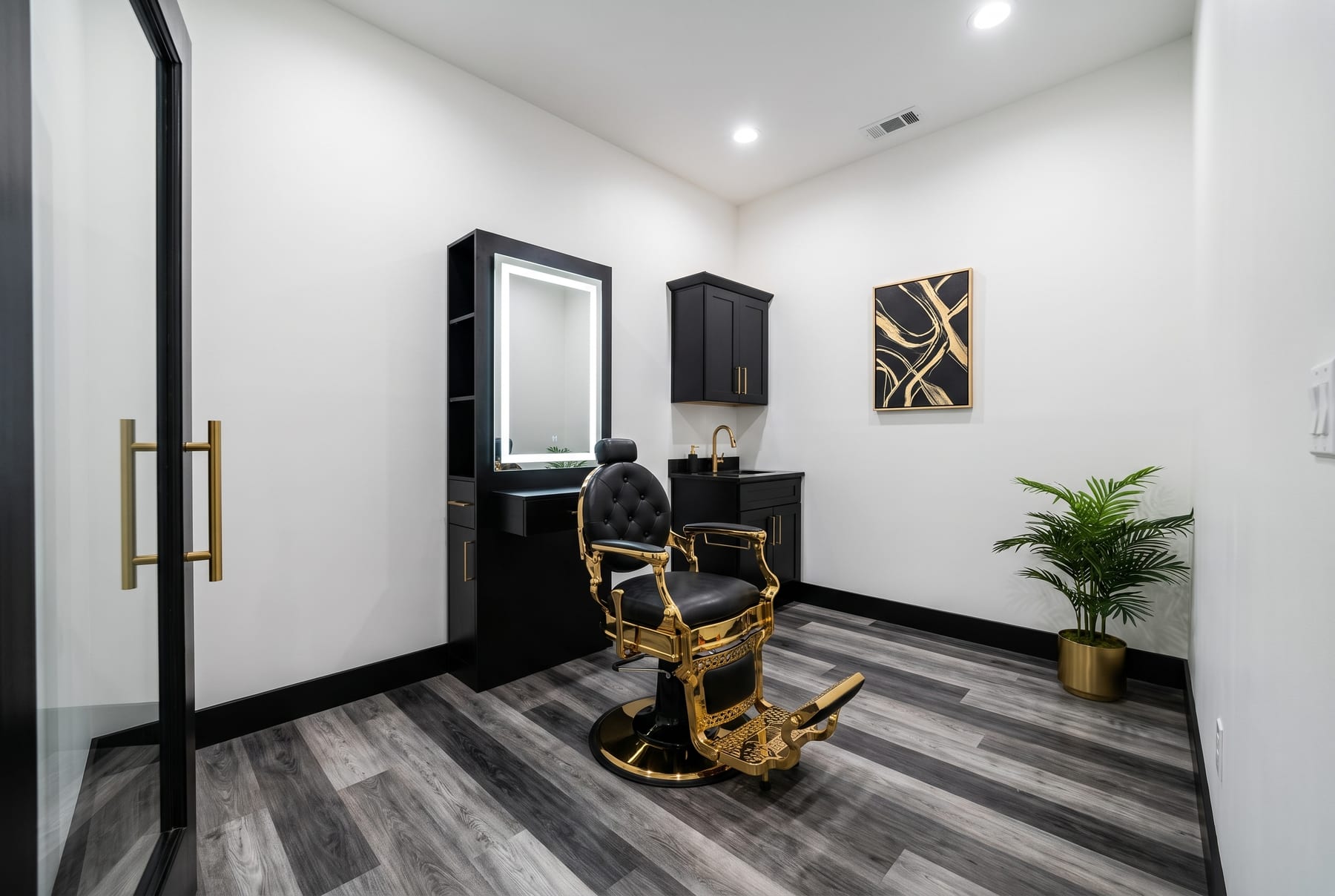 Rendering of a barber suite with a barber chair, LED-lit station and private sink